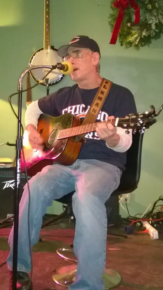 Mike Bollig singing with acoustic guitar